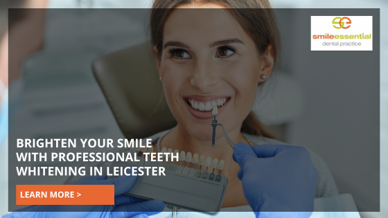 Woman checking shade of teeth for tooth whitening